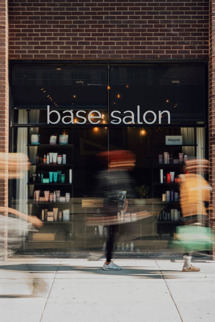 Blurred images of passersby outside Base Salon