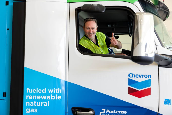 Man in cab of big rig with a thumbs-up