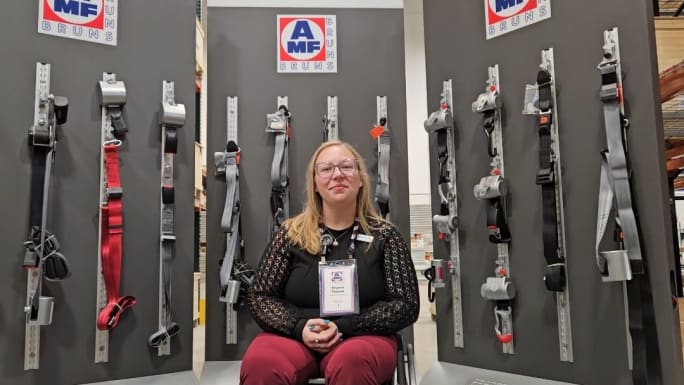 brianna pauwee sits in front of a product display