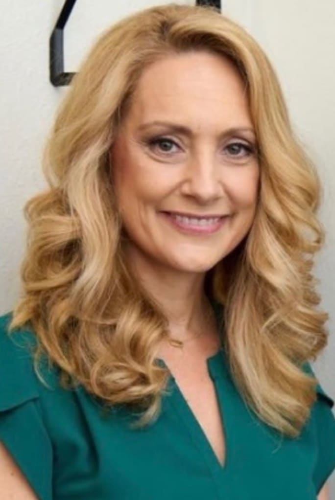 A smiling portrait of salon suite owner Amy Hazen