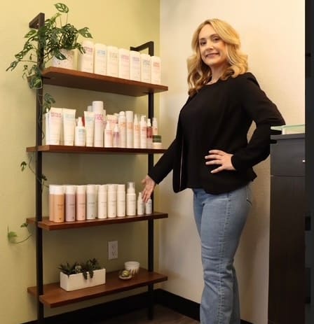Amy Hazen stands in front of her retail shelving.