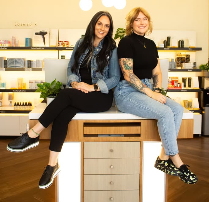 Davanti Salon Co-Owners sit on retail display