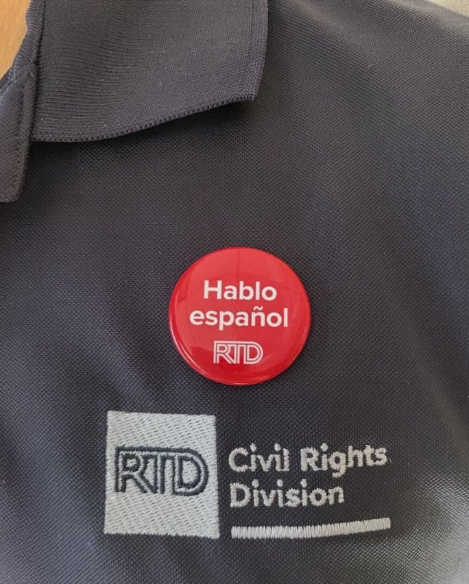 Employee shirt with Spanish-Friendly Denver RTD pin