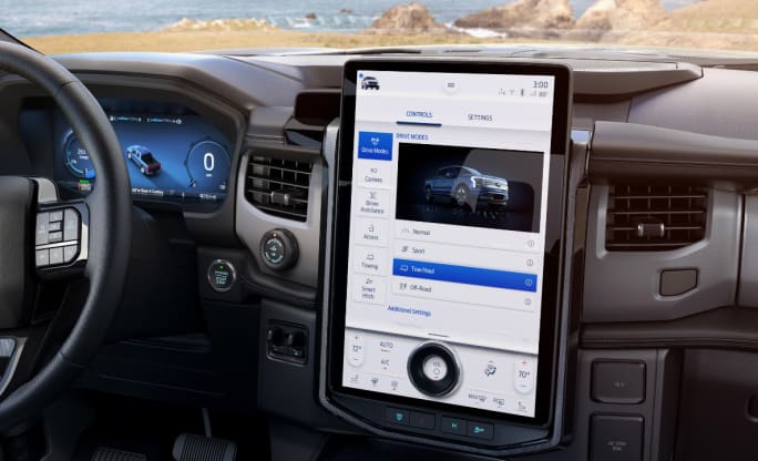 Pickup truck dashboard with a vertical iPad style computer screen showing telematics data.