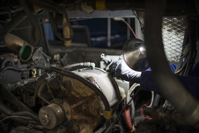 Maintenance worker performing engine work