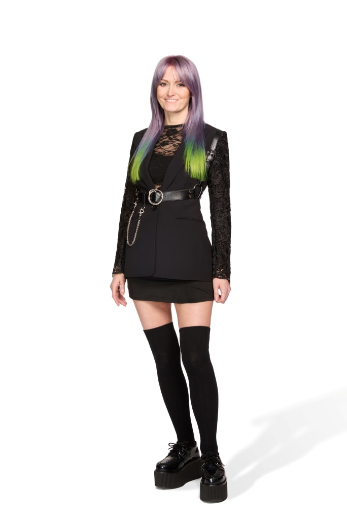 A woman in black with long green hair