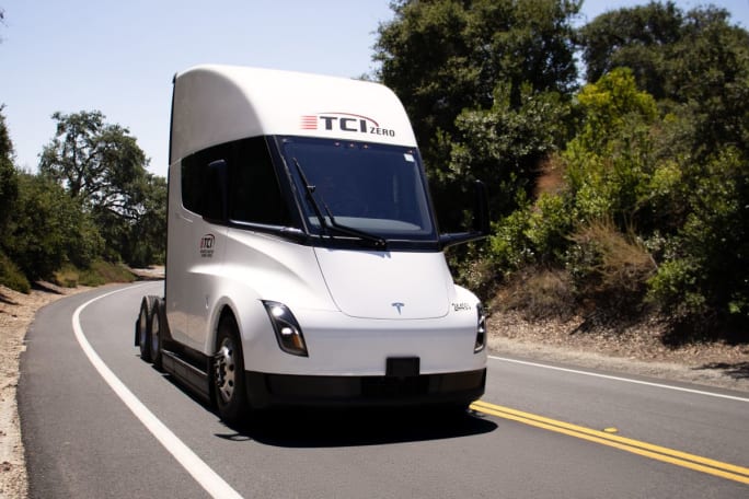 White Tesla Semi truck with TCI logo on highway