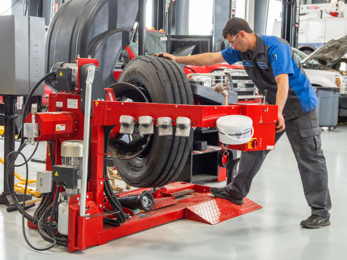 a man demonstrates the heavy duty tire changer product