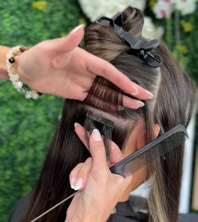 hands installing a tape-in extension