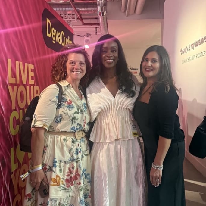 three women standing together for a photo