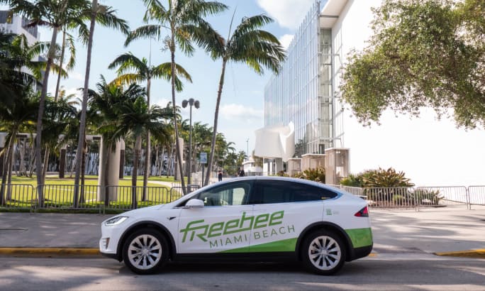 A green and white Freebee microtransit vehicle.