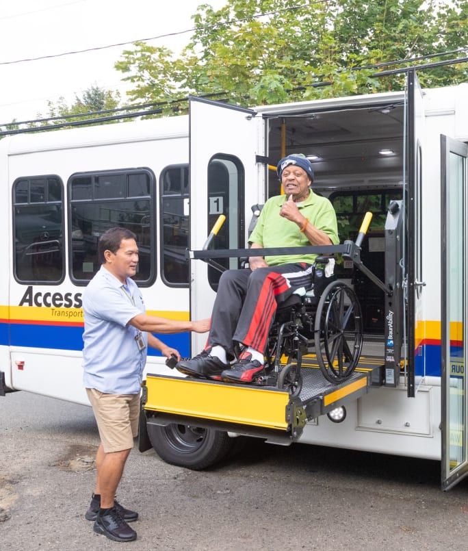 A King County Metro paratransit customer being lifted onto a vehicle.