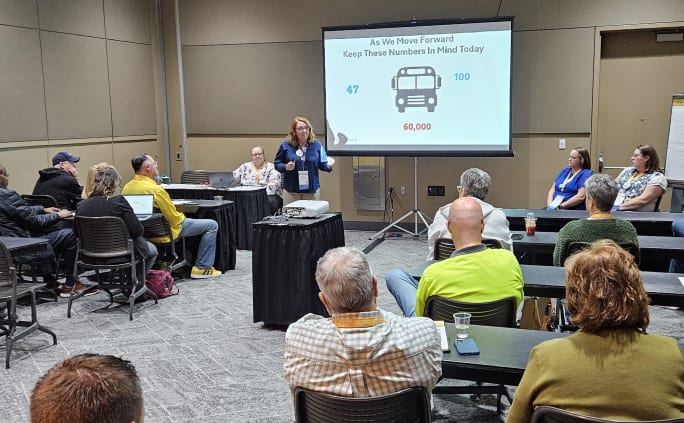 Kellie presents on emotional intelligence to a crowd of people at an event