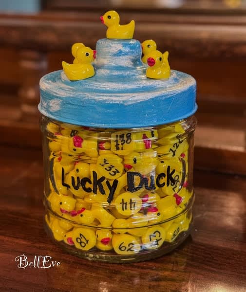 a glass full of little toy ducks