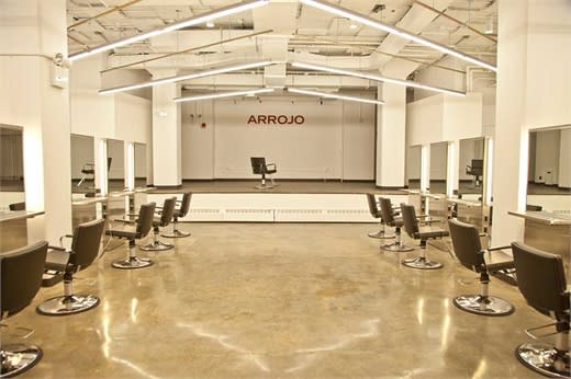 Arrojo Cosmetology School's clinic with mezzanine stage.