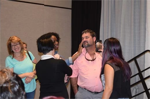 Attendees feel this a male attendee's freshly shaved face.
