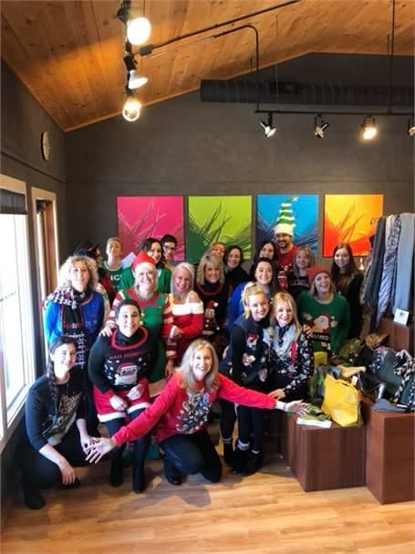 Sporting the ugly holiday sweaters, the team from Impressions in Mequon, Wisconsin.