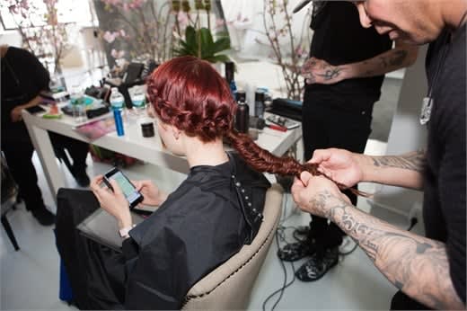 With the remaining hair, create a herringbone braid and secure with a elastic at the ends. Pull at the edges of the braid to create a tethered and voluminous look.