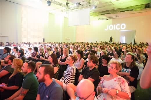 A packed room of attendees during education.