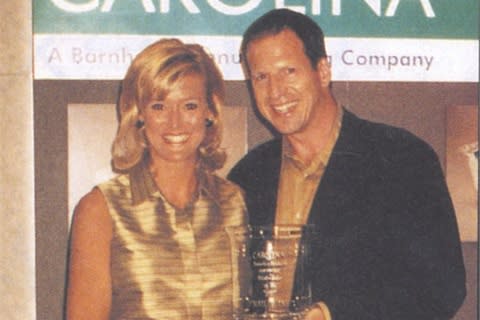 Carolina's Kristel Dean presents Nailco's present Larry Gaynor with the 1997-98 DIstributor of the Year Award.