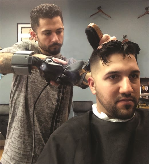 Silvestro's new prosthetic hand that helps him barber.