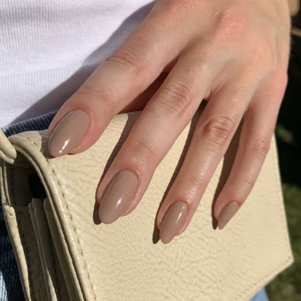 A closeup of a hand on a purse
