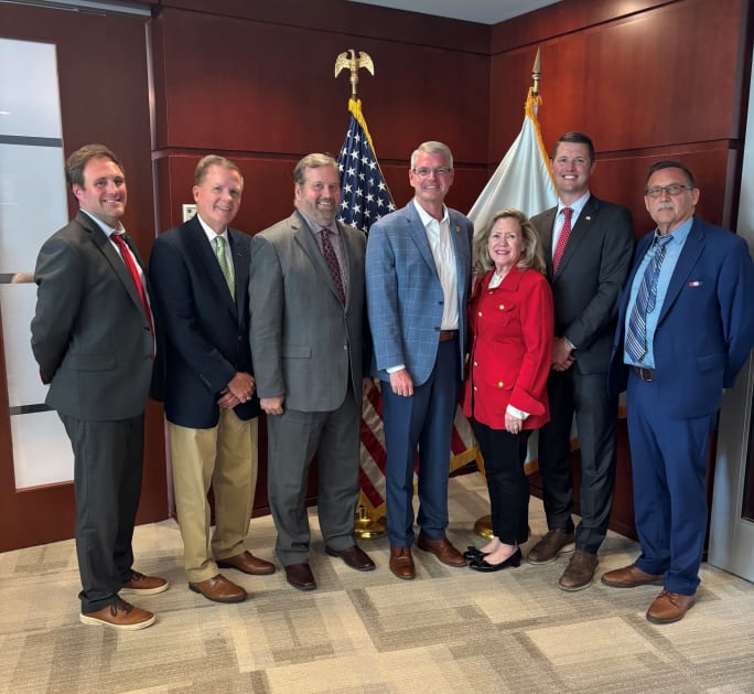 NSTA leaders pose with FMCSA Administrator Derek Barrs in Washington, D.C., following a meeting to discuss school transportation priorities, including CDL testing, insurance, regulatory updates, and safety initiatives.