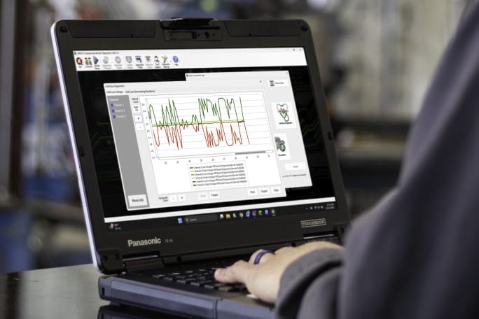 photo of a laptop with diagnostic reports shown on screen