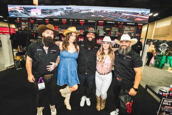 Men and women dressed in cowboy boots and hats
