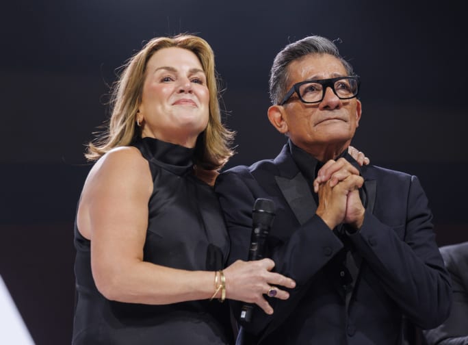 a woman standing next to a man