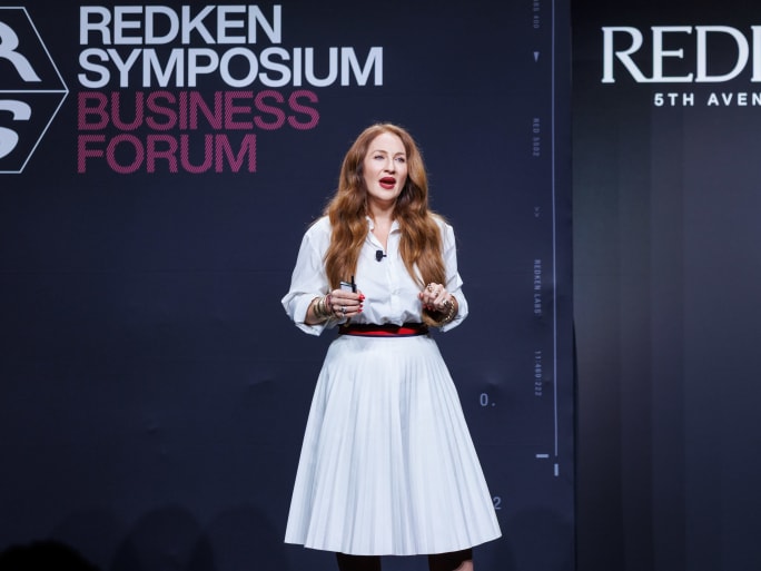 a woman giving a presentation onstage