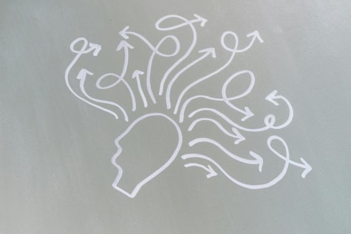Drawing of a human head with various drawn arrows pointing outward from it