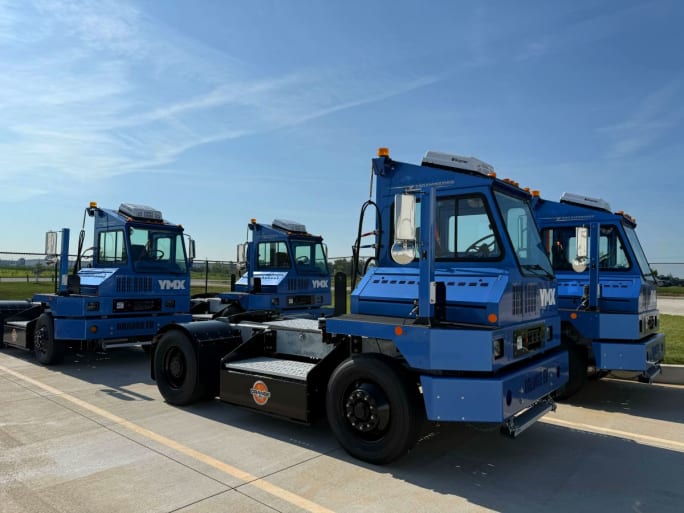 Four blue electric yard tractors