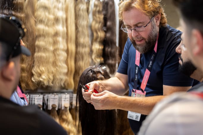A man shows people hair extensions