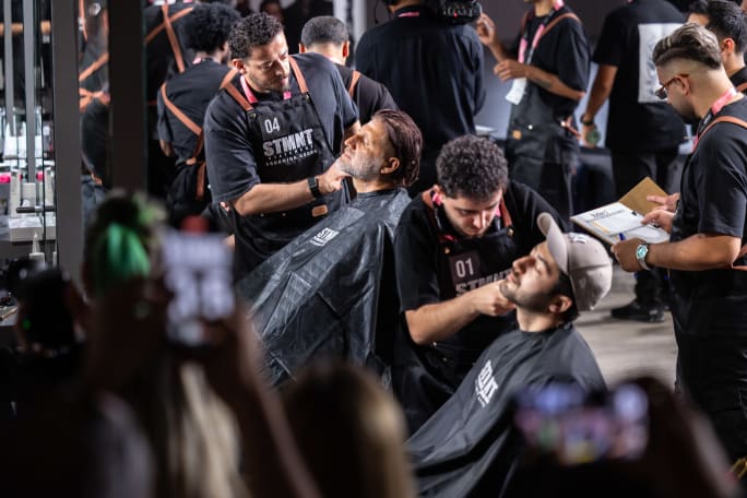 Several barbers work on several clients