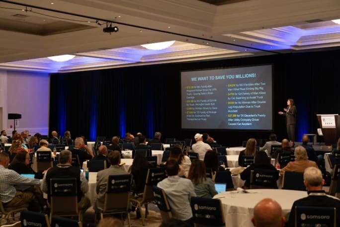 Wide shot of attendees watching keynote address.