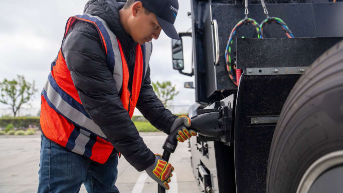 Amazon driver charging an electric truck. 