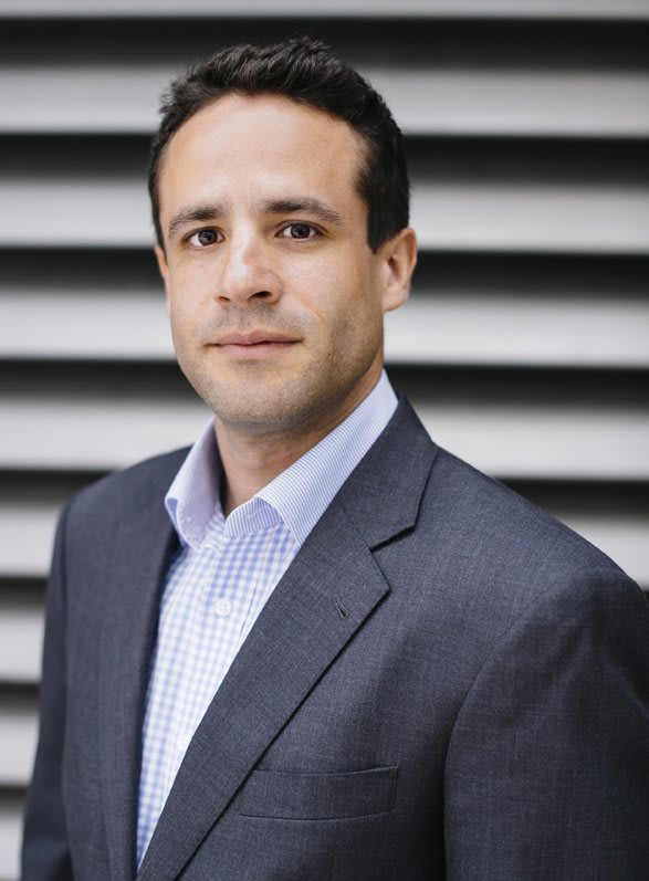 Professional business headshot of Mike Branch in a blue and gray suit.