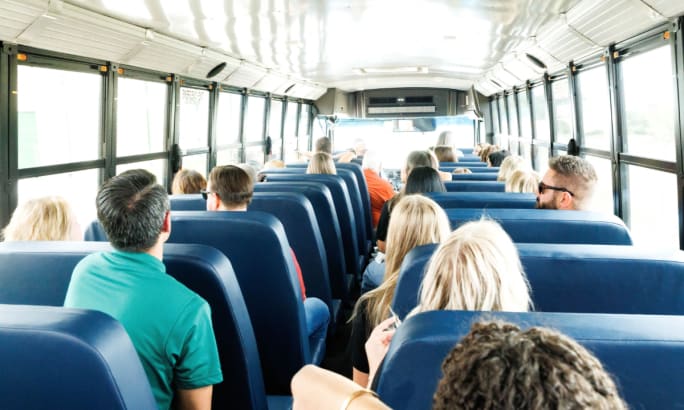 Back-to-school event attendees taking a ride in an electric bus.