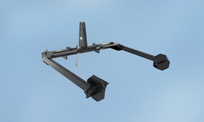 Bobcat bale unroller attachment for lifting and unrolling large round hay bales.