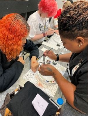 Two women painting their nails.