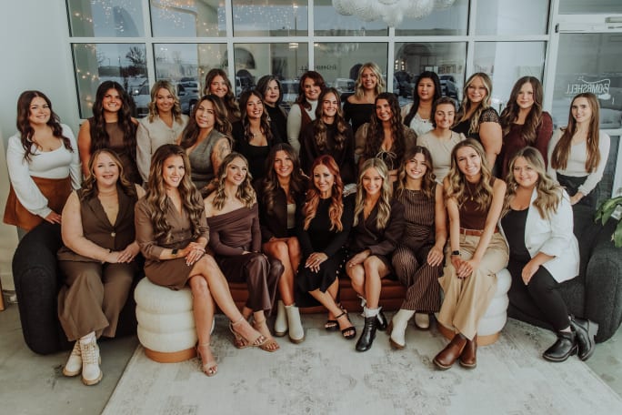 Dressed in muted natural tones, the team from Bombshell Salon and Spa.