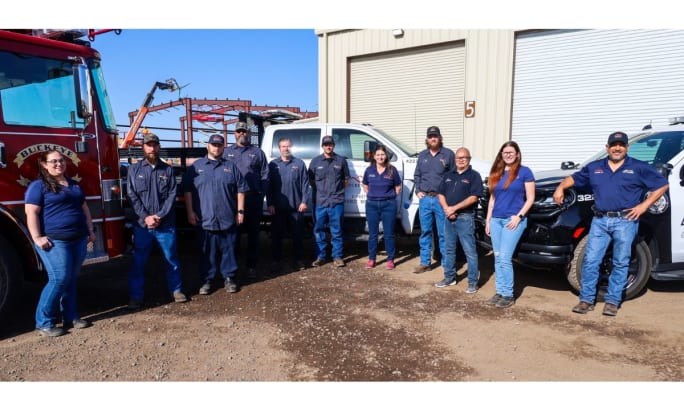 A group of employees from the Buckeye, Arizona, Public Works Fleet management department pose for a picture in front of some of their fleet. 