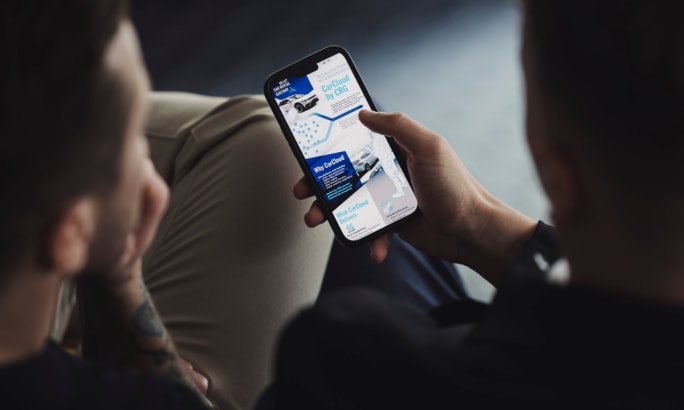 Two people looking at a smartphone screen.