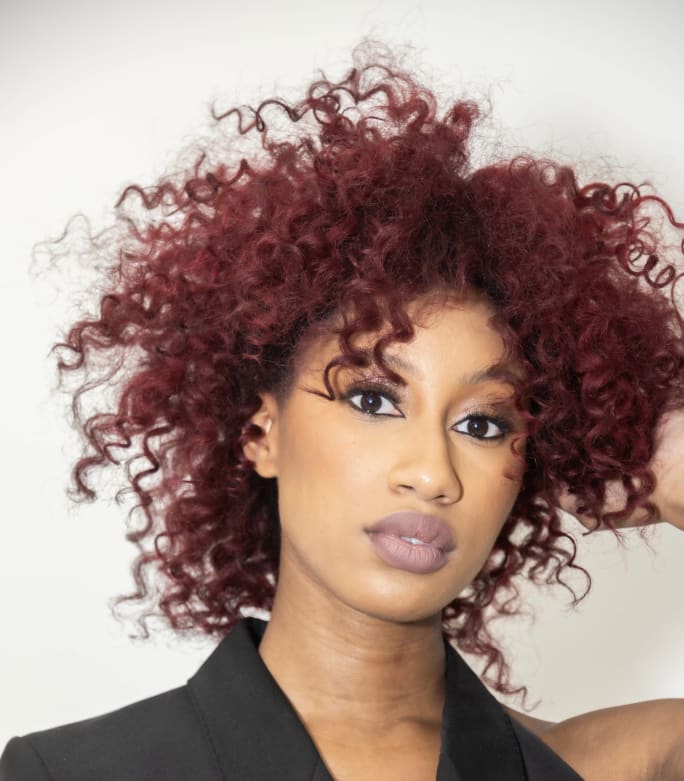 A woman with red, curly hair