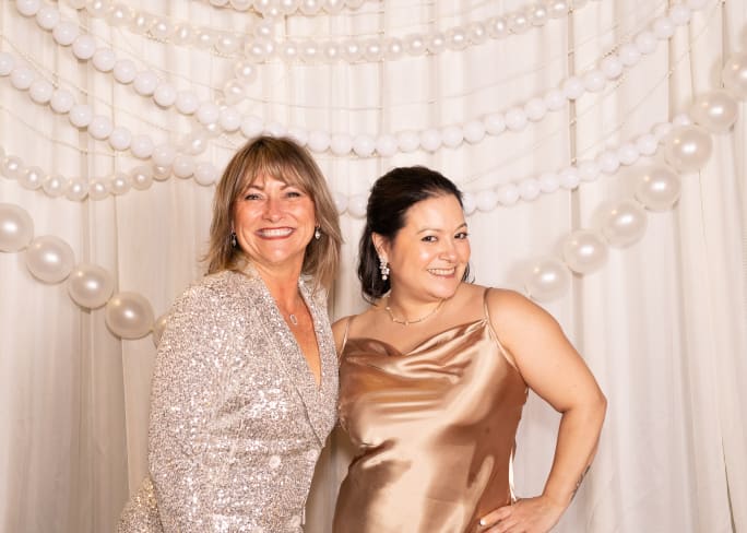 Cynthia Perry and Karla Patterson dressed in champagne-colored sparkle shine like the strong women they are.