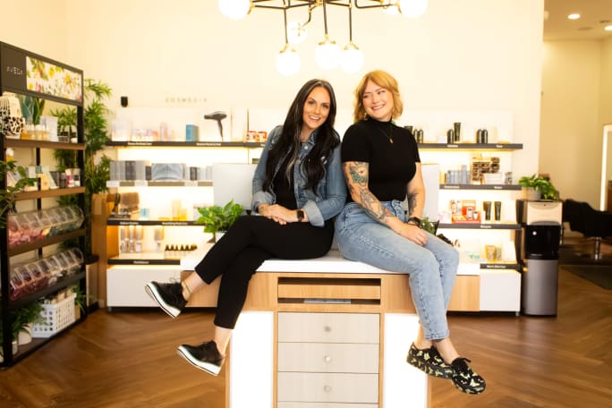 Two owners atop an island in the retail area of Davanti Salon.