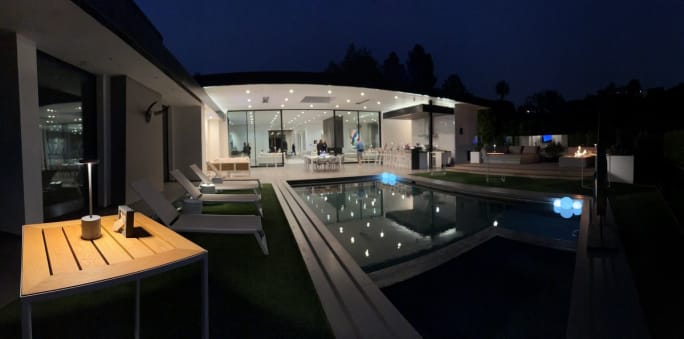 Luxury midcentury modern house at night from outside.