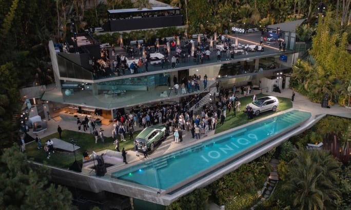 The new Hyundai Ioniq 9 unveiled outside at the multi-tiered Goldstein House in Beverly Hills. A pool with the words 