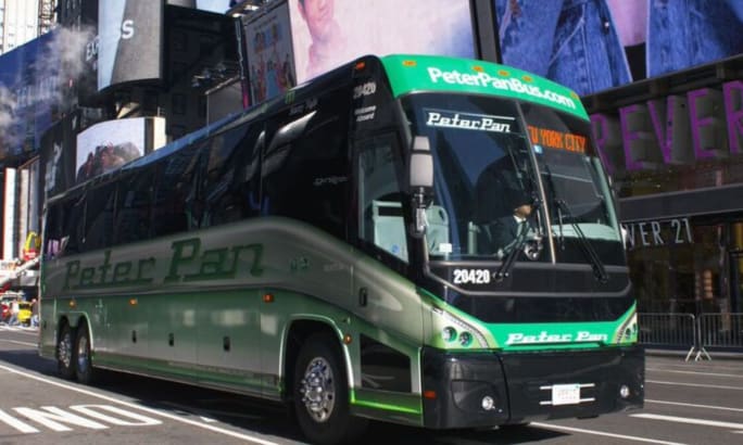 A green and black Peter Pan Bus Lines motorcoach in New York City.